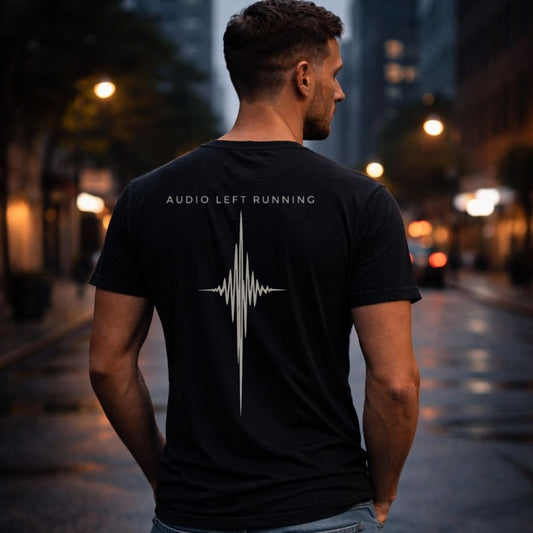 Male model wearing black Audio Left Running back print shirt at dusk city street