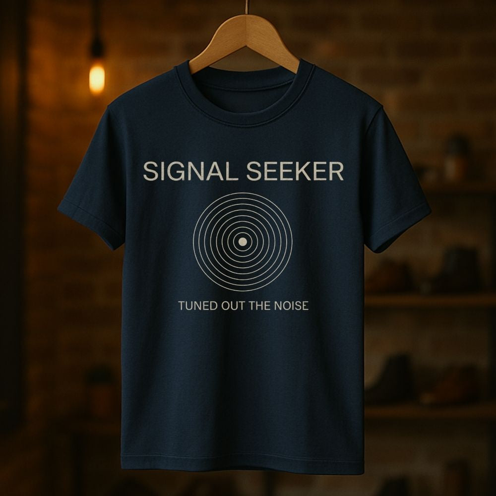 Navy blue t-shirt with 'Signal Seeker' text and design on a wooden hanger against a dark background
