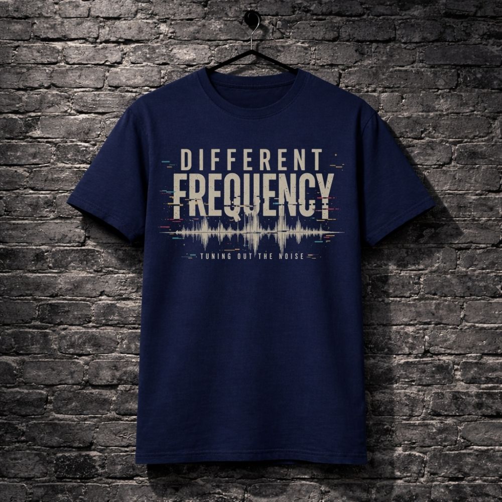 Navy blue t-shirt with 'Different Frequency' design on a brick wall background