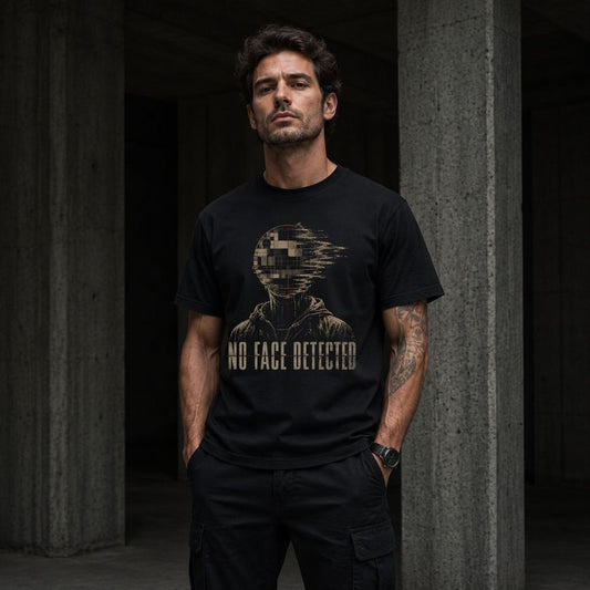 Man wearing a black t-shirt with a graphic design and text, standing against a dark background.