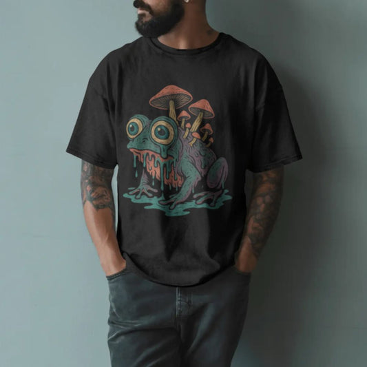 Male model wearing black surreal frog and mushroom graphic T-shirt with psychedelic illustration