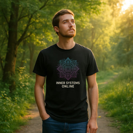 Man standing in a forest wearing black “Inner Systems Online” T-shirt with neon mandala tech design, peaceful outdoor lighting.