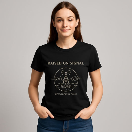 Person wearing a black t-shirt with 'Raised on Signal' design on a gray background