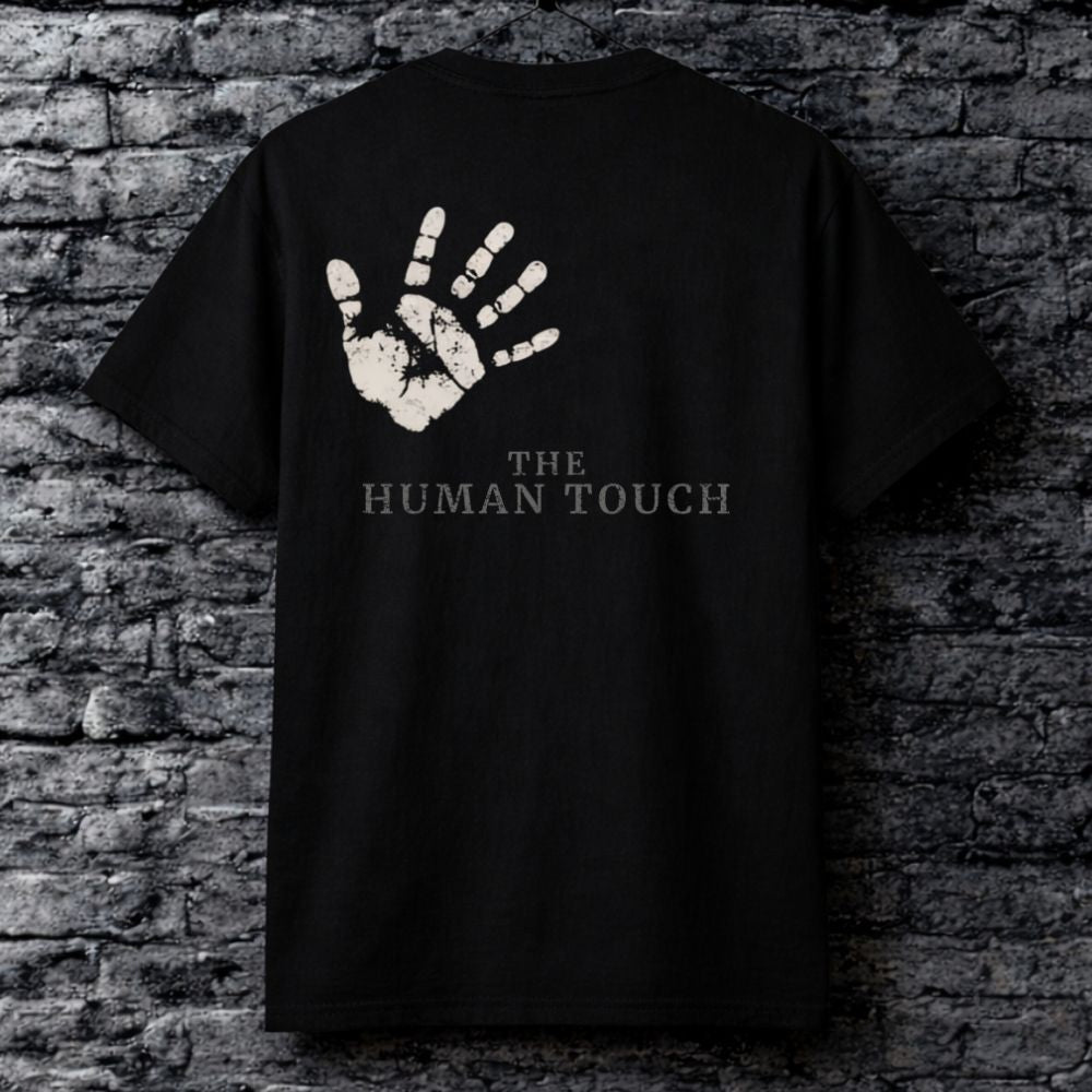 Black t-shirt with a handprint design and 'The Human Touch' text on a brick wall background