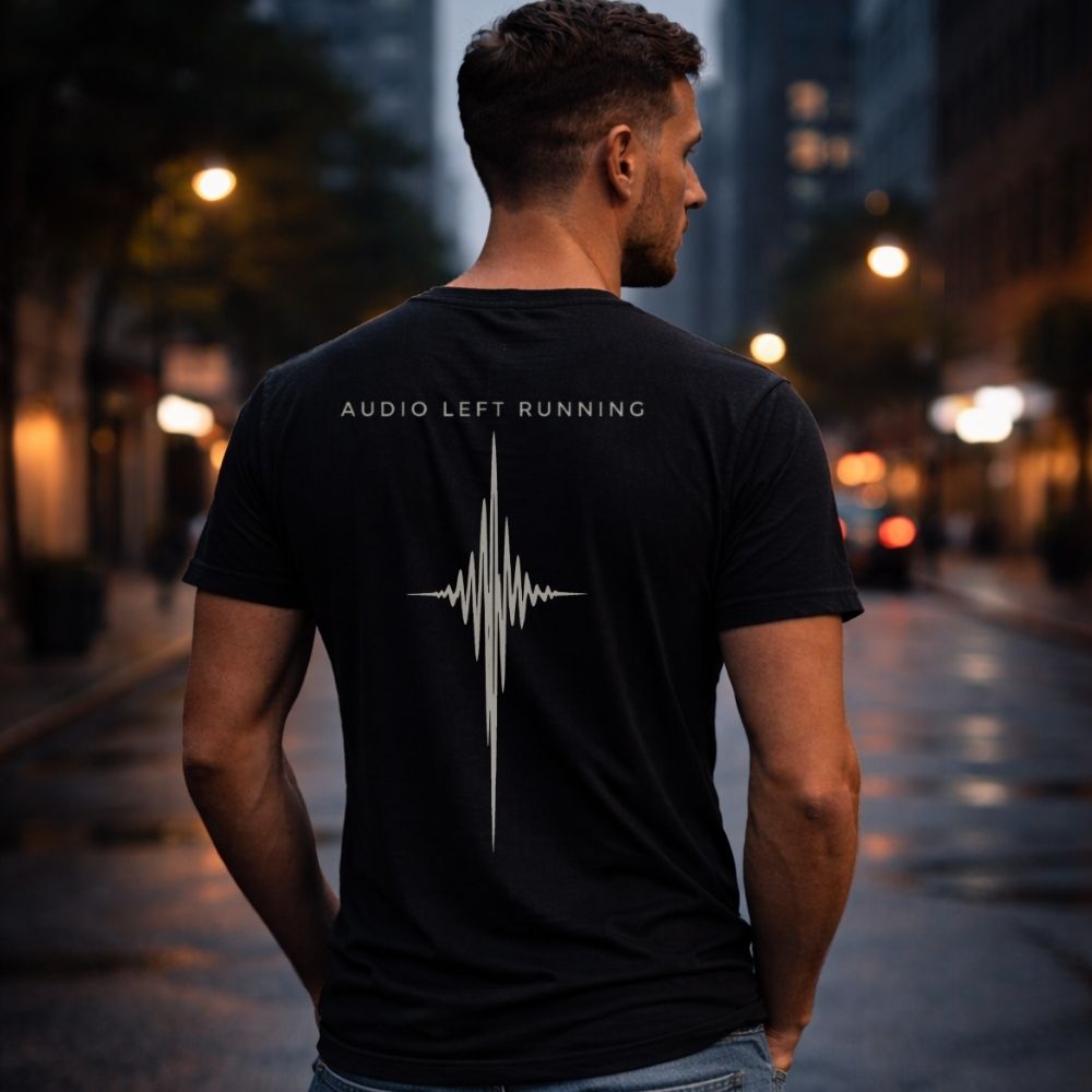 Male model wearing black Audio Left Running back print shirt at dusk city street