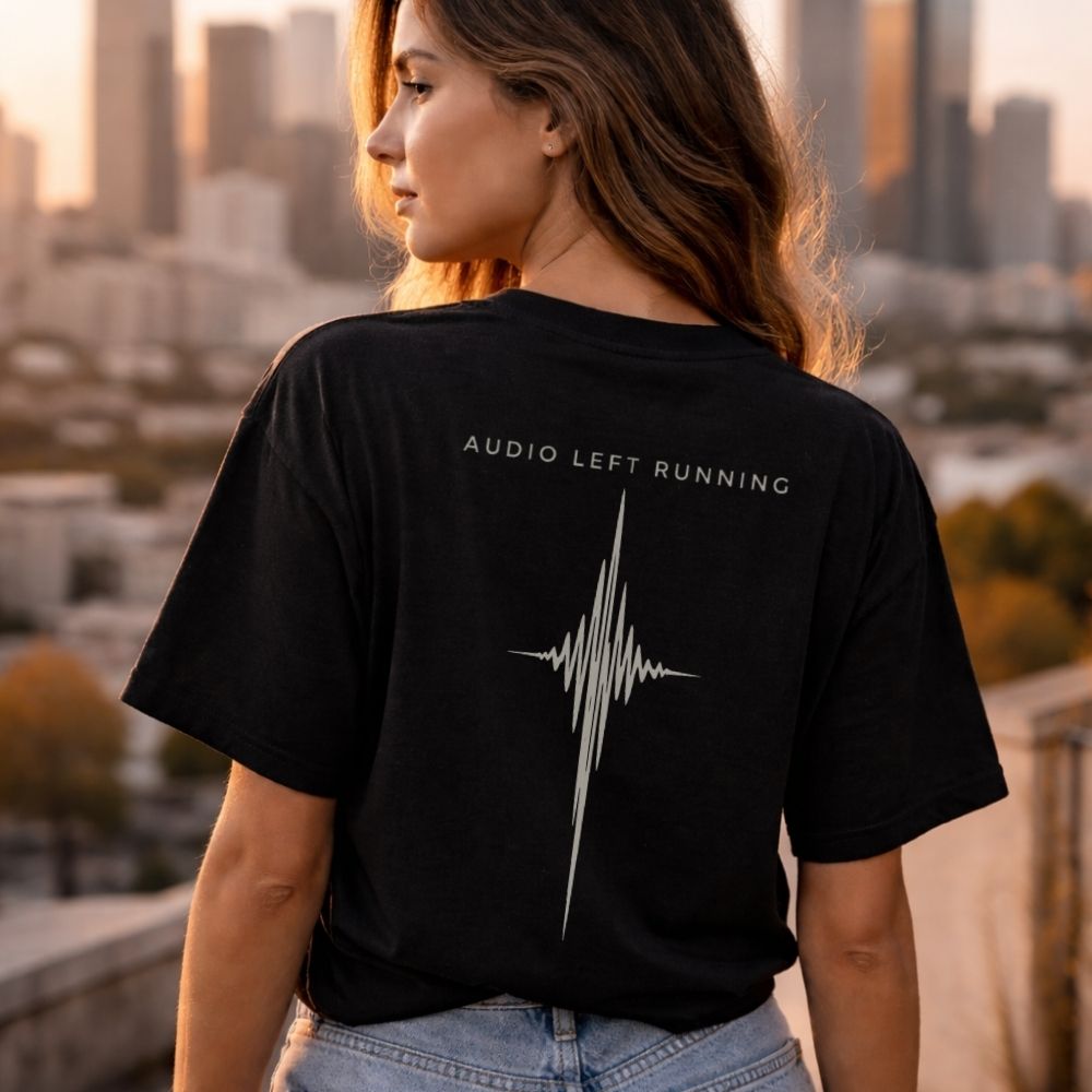 Female model wearing black minimalist waveform tee overlooking skyline