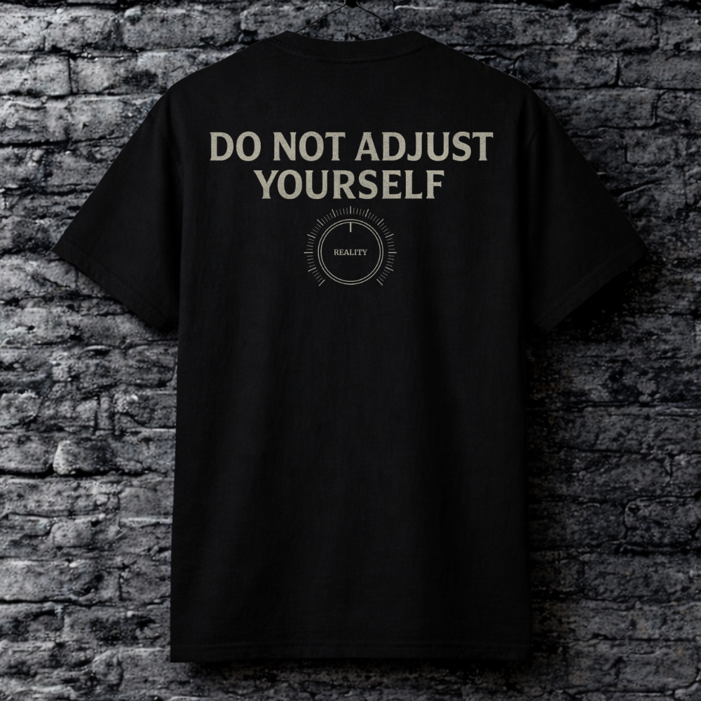 Black t-shirt with 'DO NOT ADJUST YOURSELF' text on a brick wall background