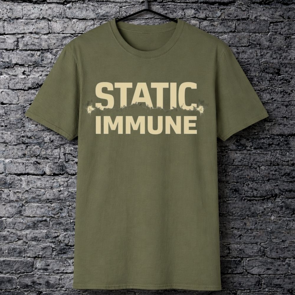 Green t-shirt with 'STATIC IMMUNE' text on a brick wall background