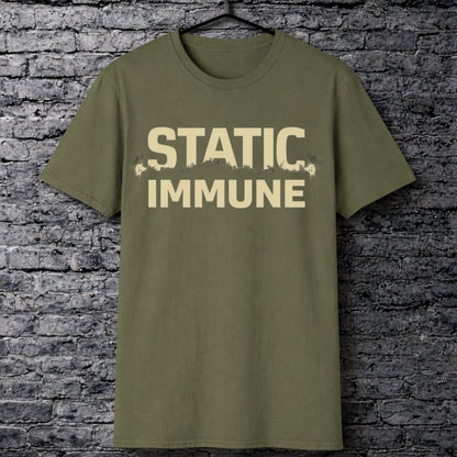 Green t-shirt with 'STATIC IMMUNE' text on a brick wall background
