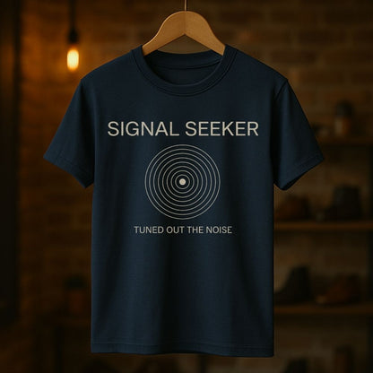 Navy blue t-shirt with 'Signal Seeker' text and design on a wooden hanger against a dark background