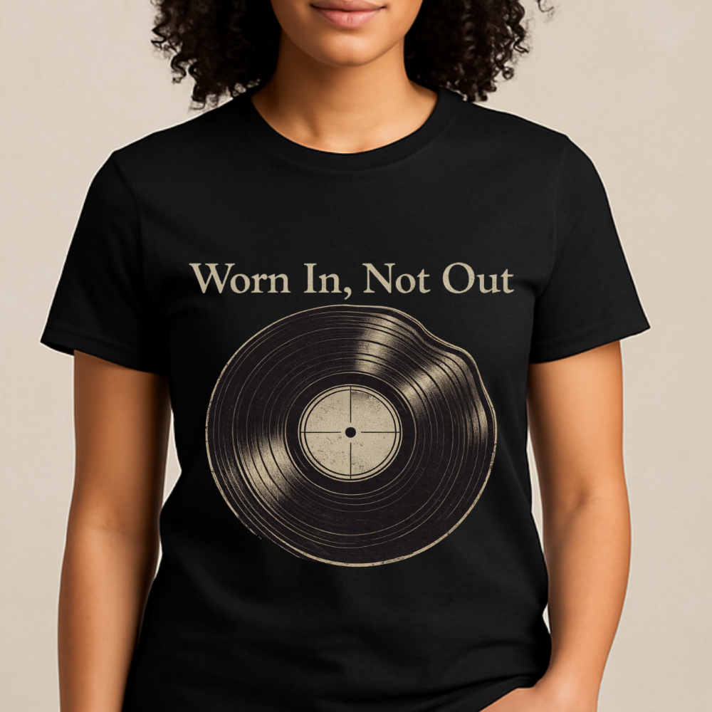 Black t-shirt with vinyl record graphic and 'Worn In, Not Out' text worn by a person.