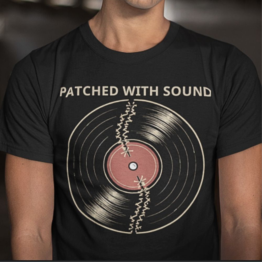 Black t-shirt with vinyl record graphic and 'Patched with Sound' text on a blurred background