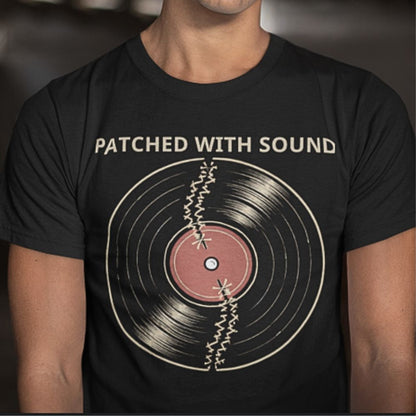 Black t-shirt with vinyl record graphic and 'Patched with Sound' text on a blurred background