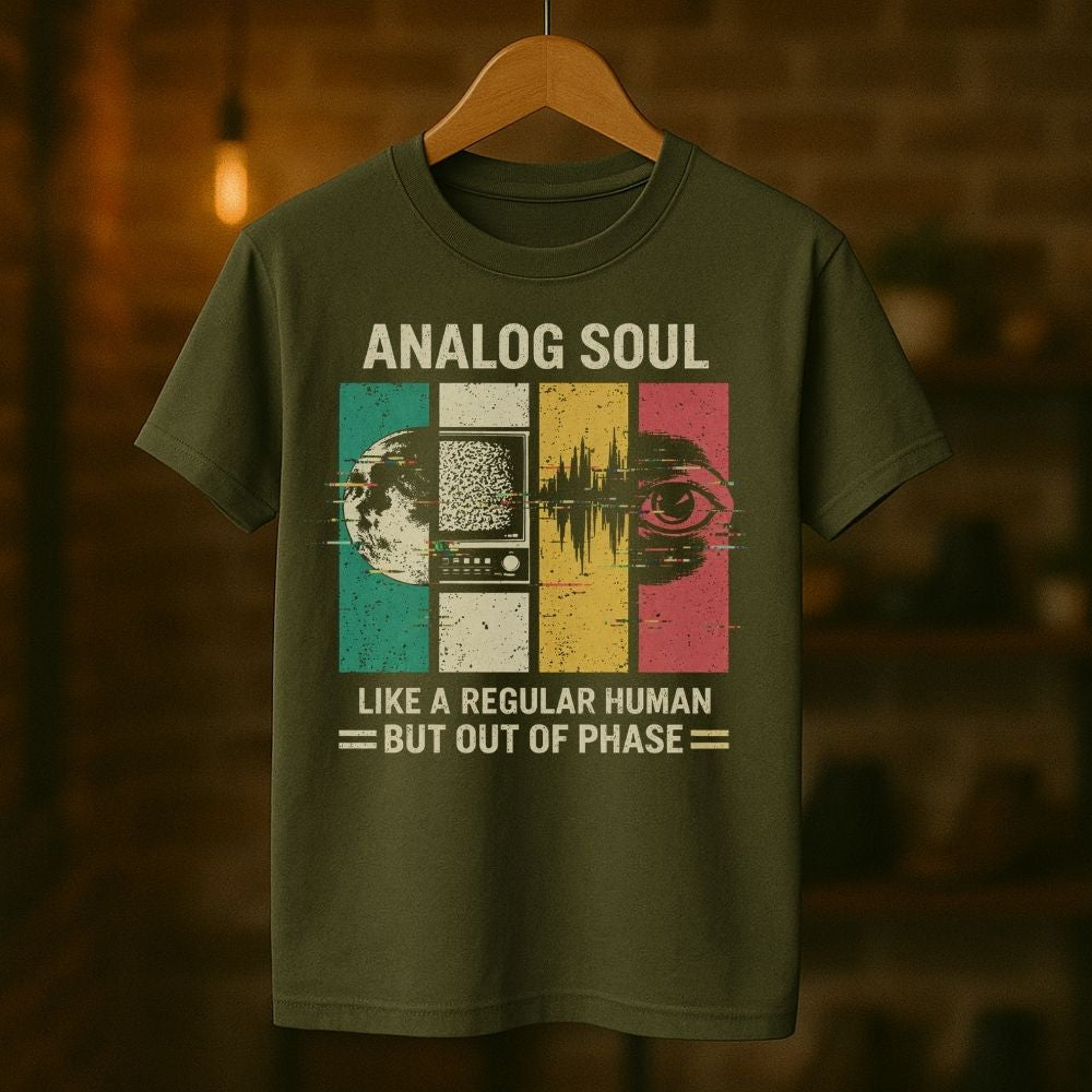 Green t-shirt with 'Analog Soul' design on a wooden hanger against a blurred background