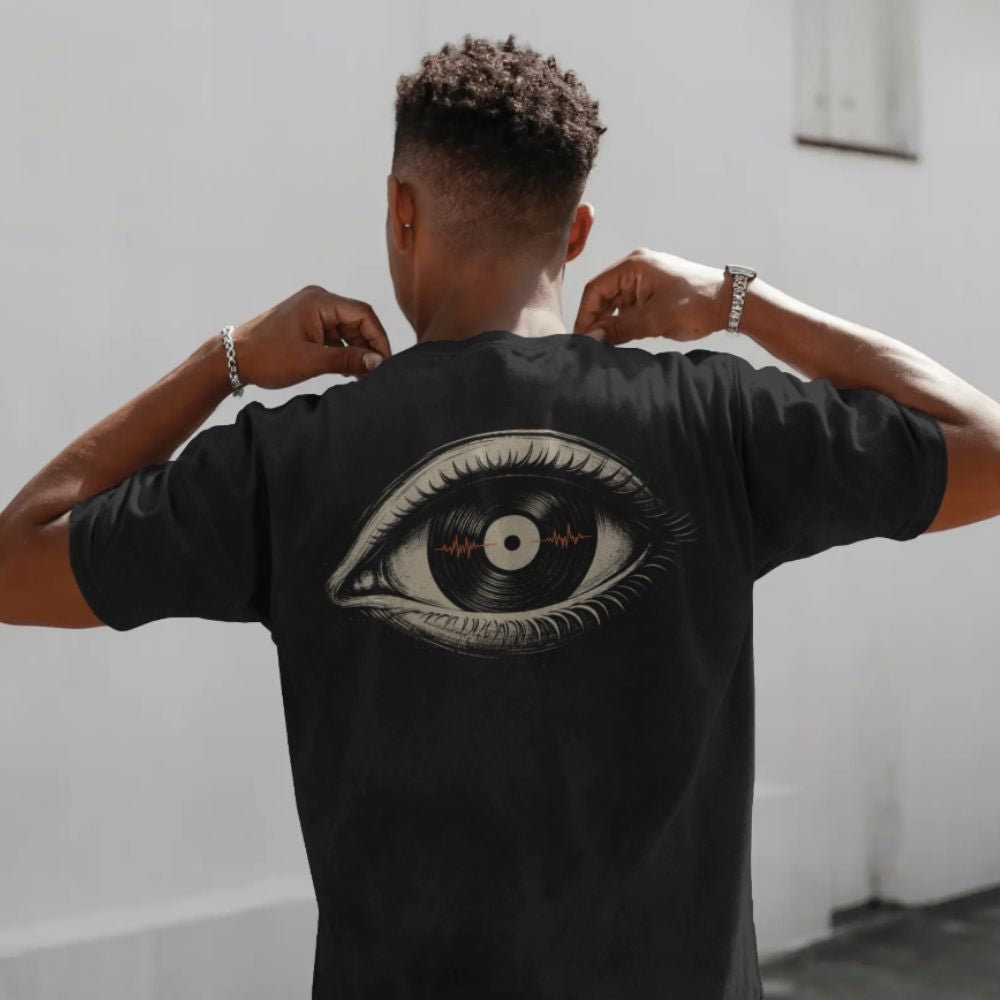 Person wearing a black t-shirt with a unique design on the back, standing against a plain background.