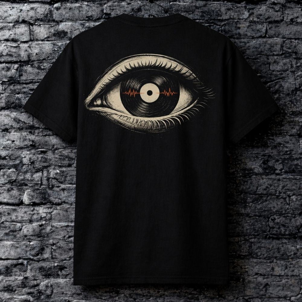 Black t-shirt with eye design featuring a vinyl record against a brick wall.