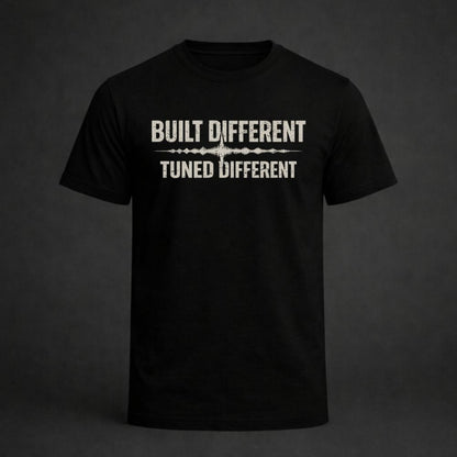 Black t-shirt with 'Built Different Tuned Different' text on a dark background