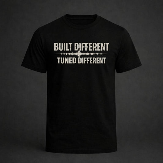 Black t-shirt with 'Built Different Tuned Different' text on a dark background