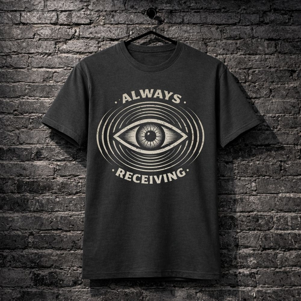 Black t-shirt with eye design and 'Always Receiving' text on a brick wall background