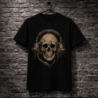 Black t-shirt with a skull and headphones design hanging against a brick wall.