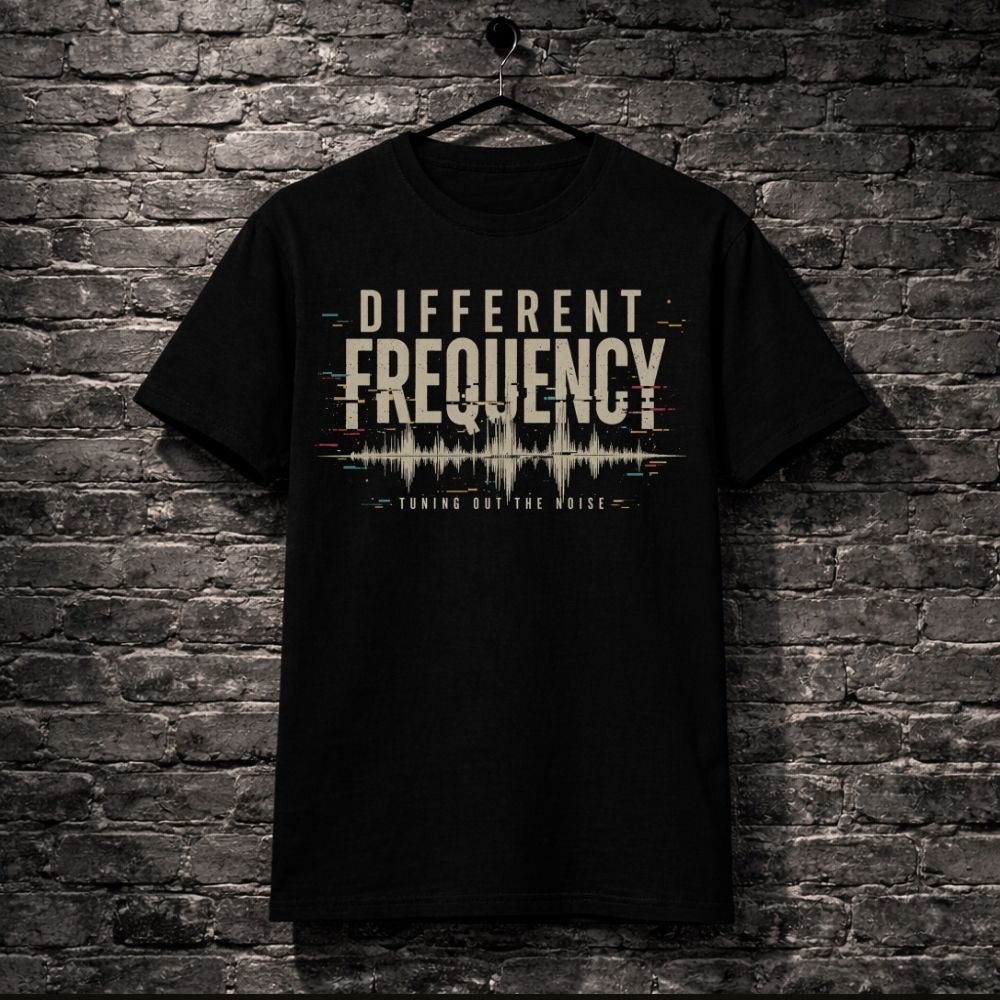 Black t-shirt with 'Different Frequency' design on a brick wall background