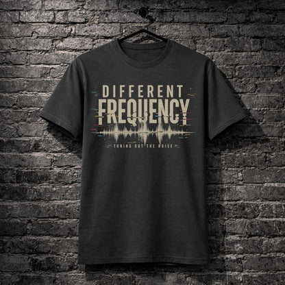 Black t-shirt with 'Different Frequency' design on a brick wall background