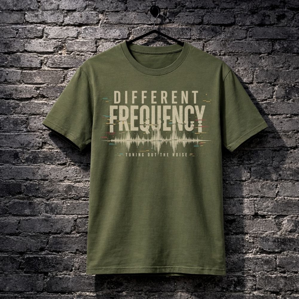 Green t-shirt with 'Different Frequency' design on a brick wall background