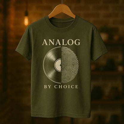 Green t-shirt with 'Analog by Choice' design on a wooden hanger against a blurred background