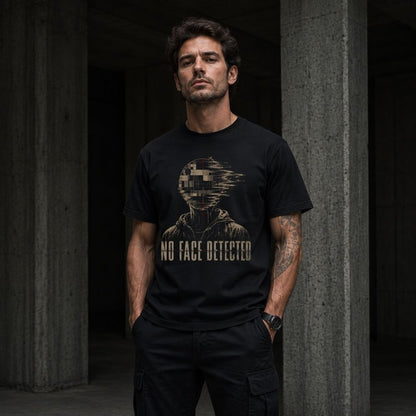 Man wearing a black t-shirt with a graphic design and text, standing against a dark background.