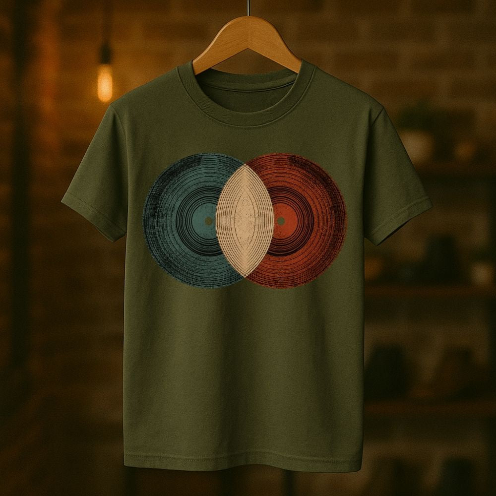 Green t-shirt with circular design on a wooden hanger against a blurred background