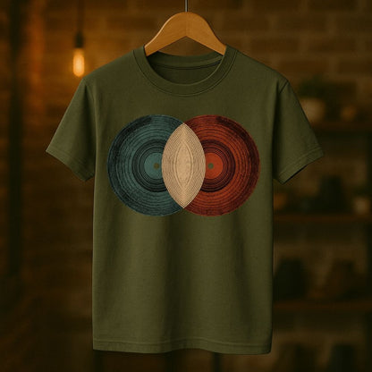 Green t-shirt with circular design on a wooden hanger against a blurred background