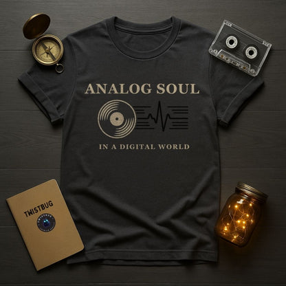 Black t-shirt with 'Analog Soul in a Digital World' design on a wooden surface with vintage items.