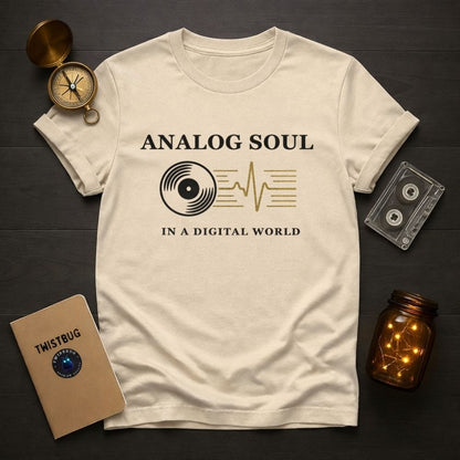Beige t-shirt with 'Analog Soul in a Digital World' design on a dark surface with vintage items.