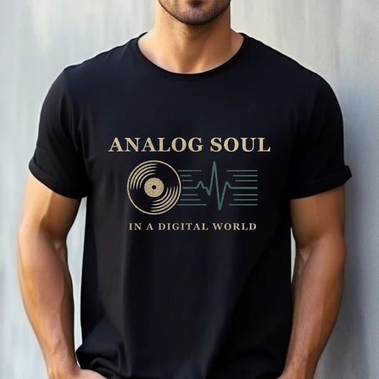 Black unisex graphic t-shirt with "Analog Soul in a Digital World" design featuring a vinyl record and heartbeat waveform, shown on a male model