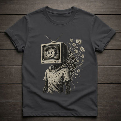 Dark gray t-shirt with a graphic design of a person with a TV for a head on a wooden surface
