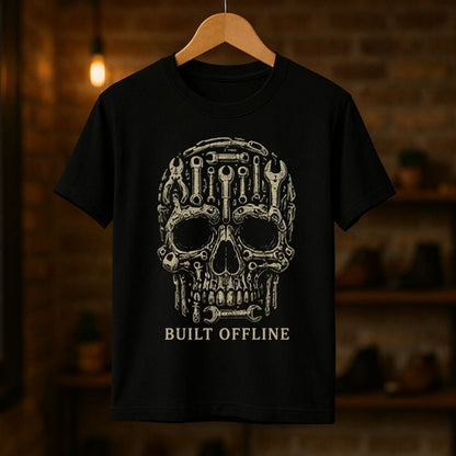 Black t-shirt with mechanical skull design and 'BUILT OFFLINE' text on a wooden hanger against a dark background.
