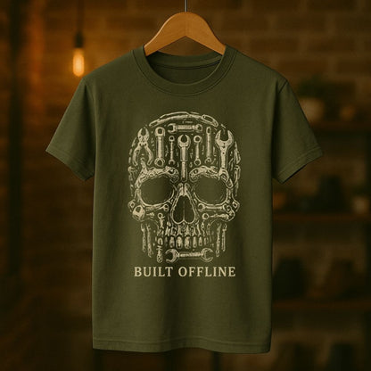 Green t-shirt with a mechanical skull design and 'BUILT OFFLINE' text on a wooden hanger against a blurred background.