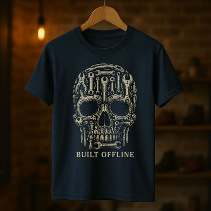Navy blue t-shirt with a skull design and 'Built Offline' text on a wooden hanger against a dark background.
