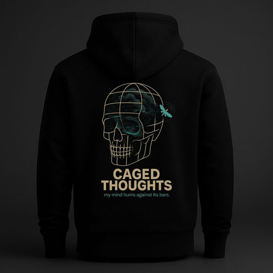 Black hoodie back view featuring a surreal skull enclosed in a geometric cage with the text “Caged Thoughts – my mind hums against its bars,” psychological streetwear design.