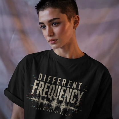Person wearing a black t-shirt with 'Different Frequency' text and sound wave design.
