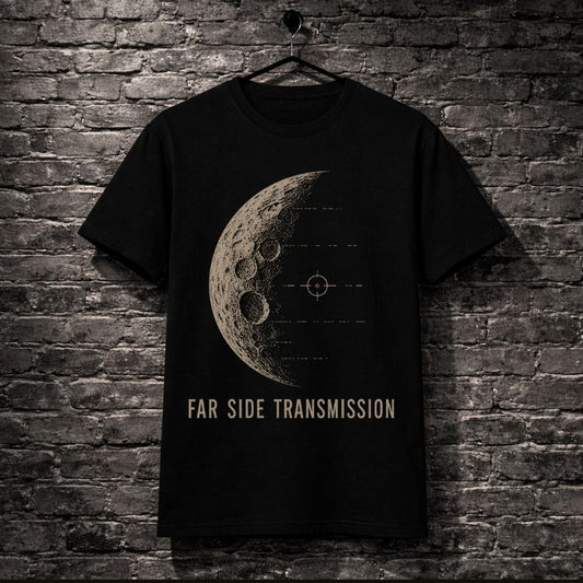 A black short-sleeve t-shirt hanging on a black hanger against a dark gray brick wall. The shirt features a beige graphic of a detailed moon with crater rings and a targeting crosshair, with the text 'FAR SIDE TRANSMISSION' printed below in beige.
