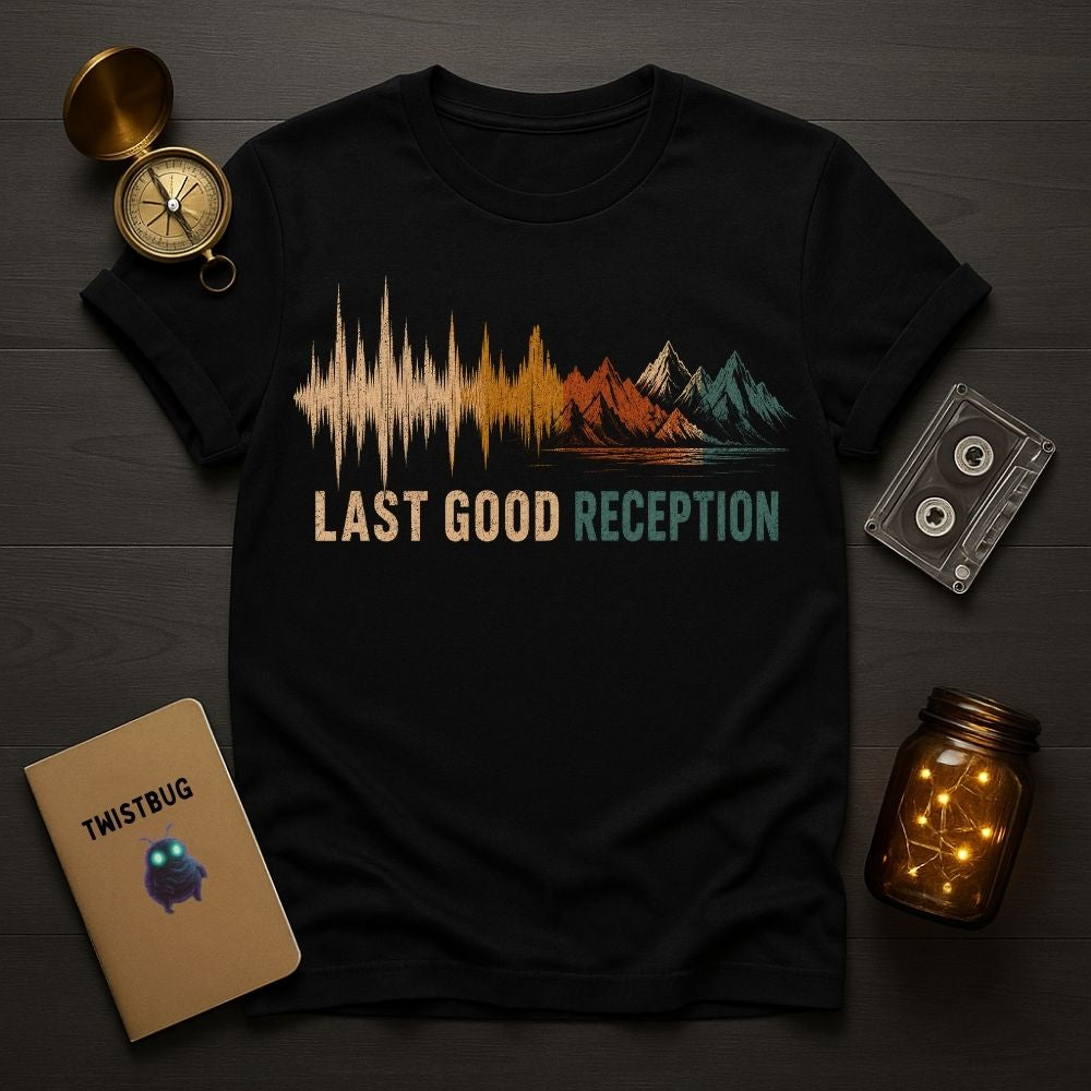 Black t-shirt with 'Last Good Reception' design on a wooden surface with decorative items.