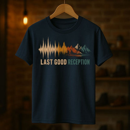 Navy blue t-shirt with 'Last Good Reception' design on a wooden hanger against a dark background