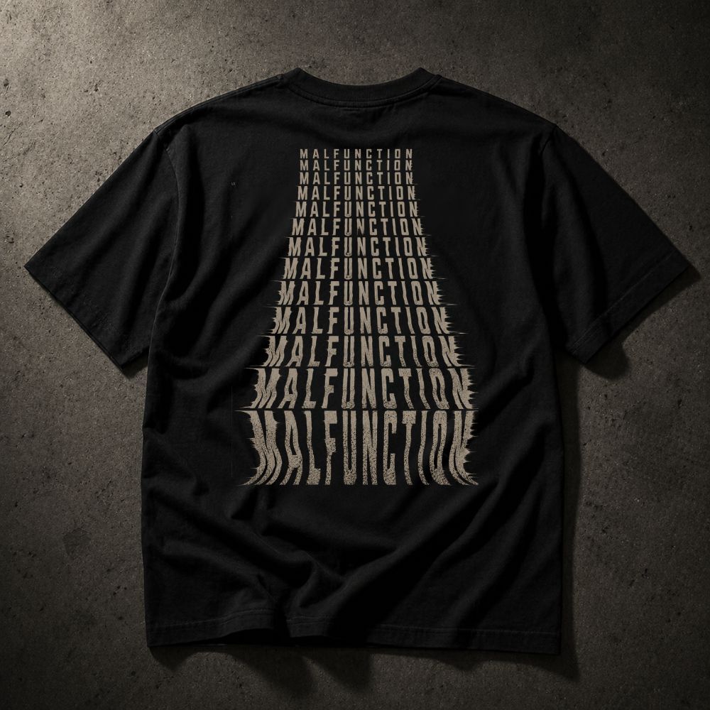 A black short-sleeve t-shirt laid flat on a dark textured background, featuring a large graphic print on the back in a distressed beige font that reads 'MALFUNCTION' repeated in a tapered shape.