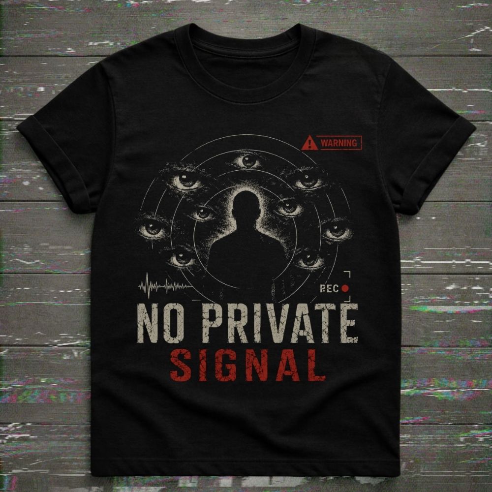 Black t-shirt with graphic design and text 'No Private Signal' on a wooden surface.