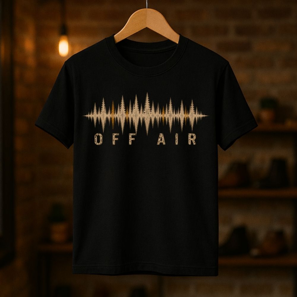 Black t-shirt with 'OFF AIR' design on a wooden hanger against a dark background