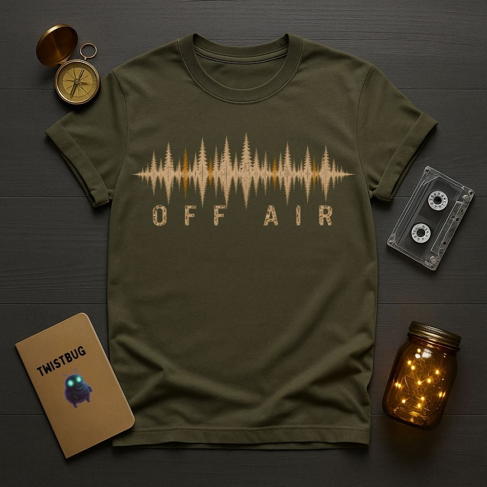 Green t-shirt with 'OFF AIR' design on a wooden surface with vintage items.