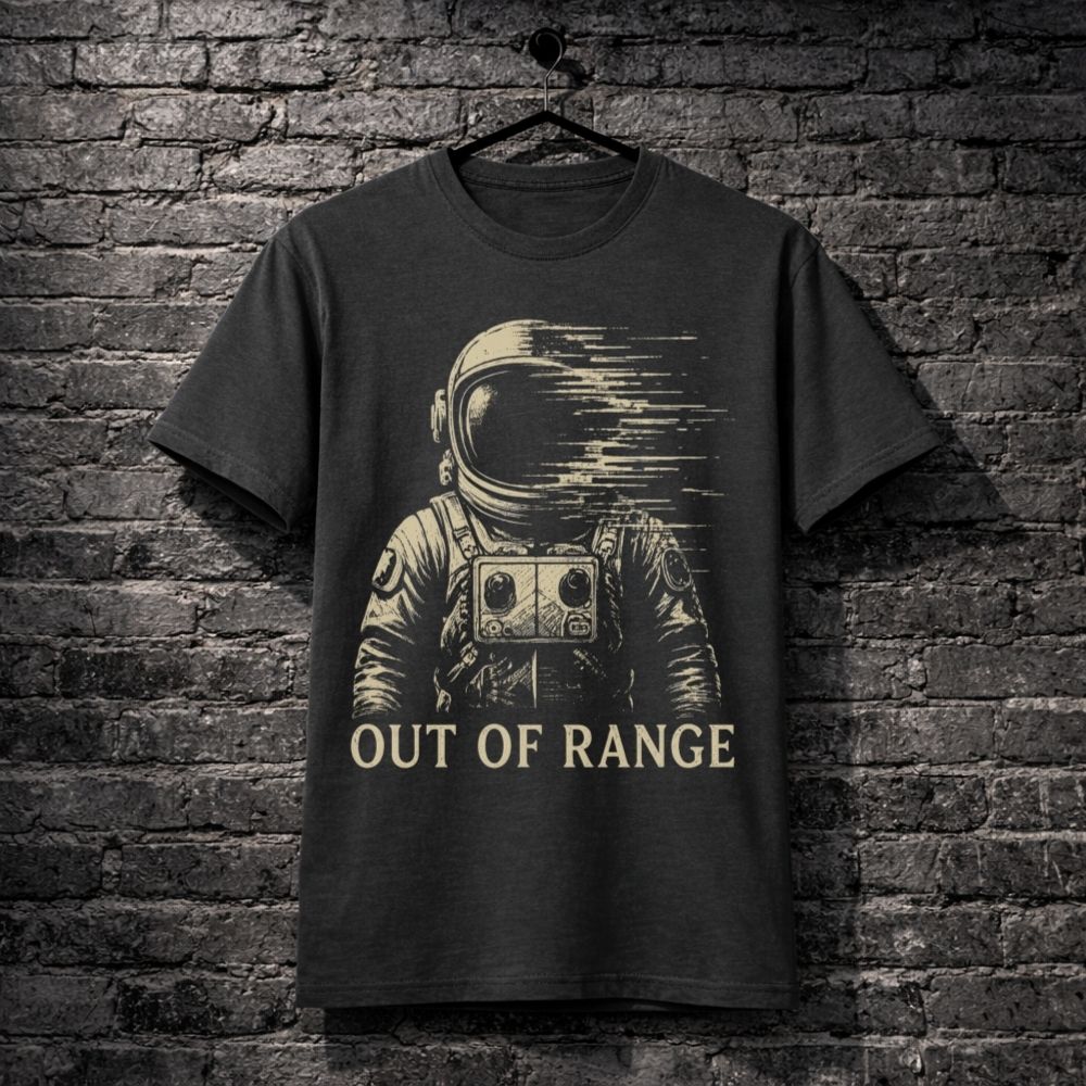 Dark t-shirt with an astronaut graphic and 'Out of Range' text on a brick wall background