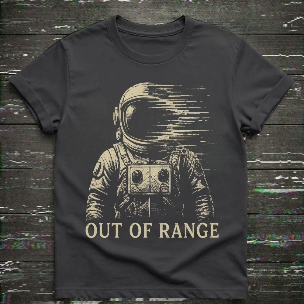Black t-shirt with an astronaut graphic and 'Out of Range' text on a wooden surface.