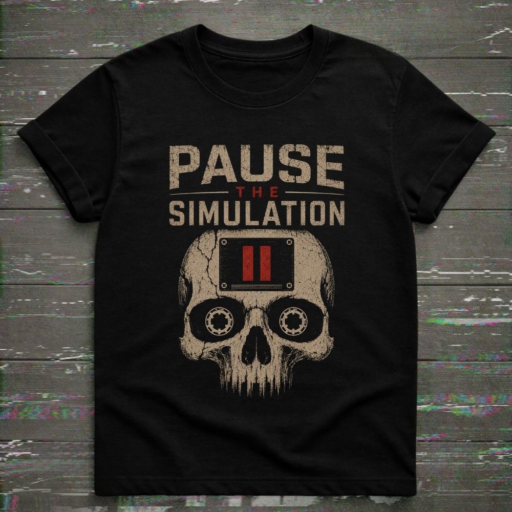 Black t-shirt with skull design and 'Pause the Simulation' text on a wooden surface.